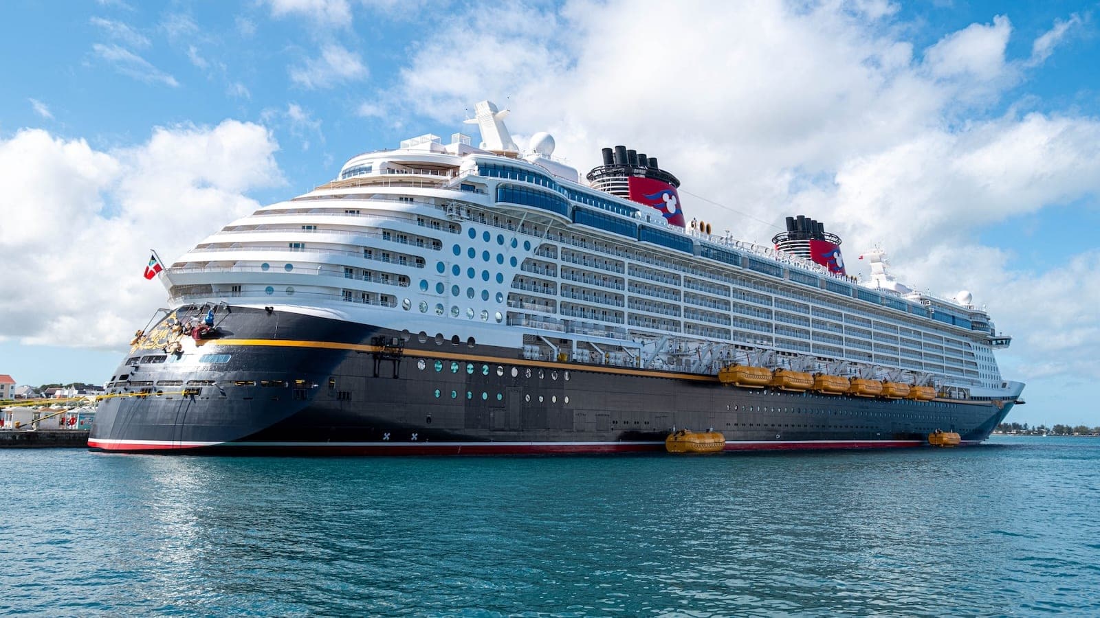 Large ocean cruise ship docked at port, representing booking and cruise payment planning.