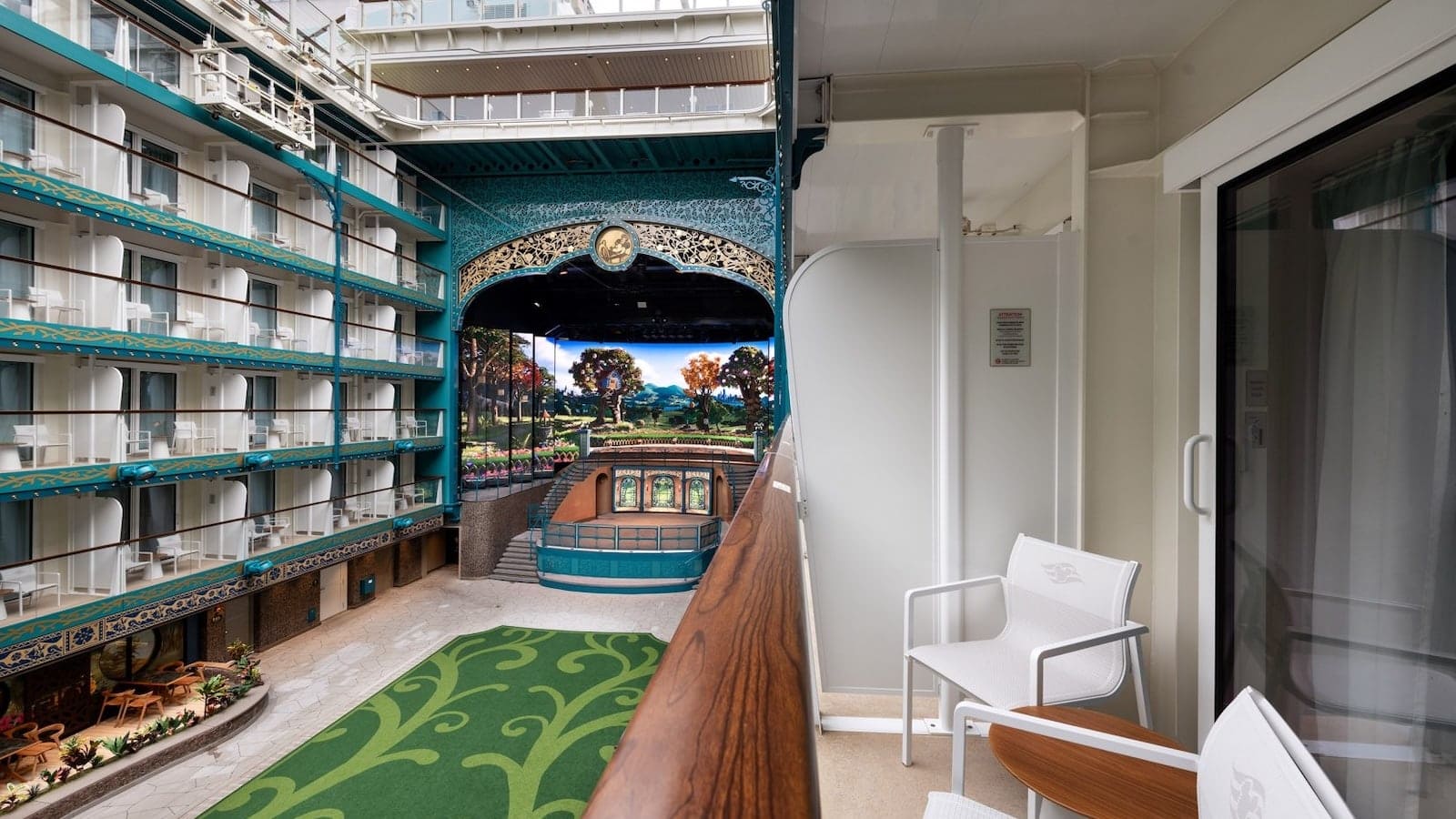 Verandah stateroom balcony view aboard the Disney Adventure cruise ship overlooking the ship’s interior garden area