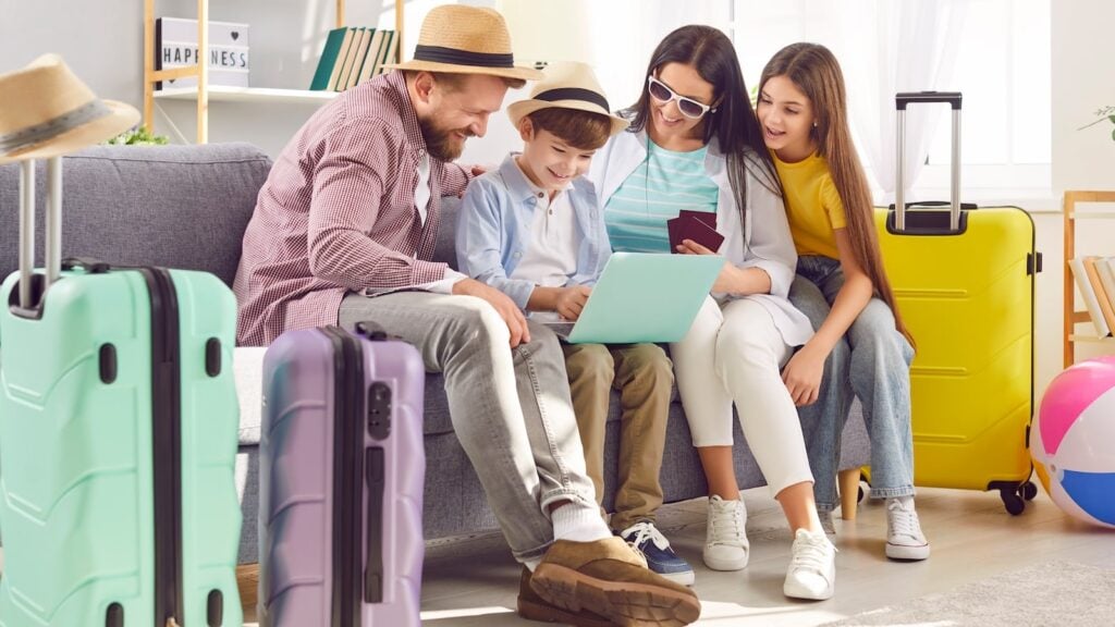 Family reviewing cruise booking details and packing checklist at home with luggage ready for embarkation day.