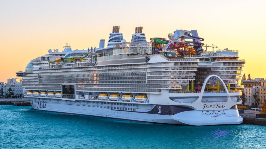 Royal Caribbean cruise ship docked at port showing balconies, decks, and family amenities.