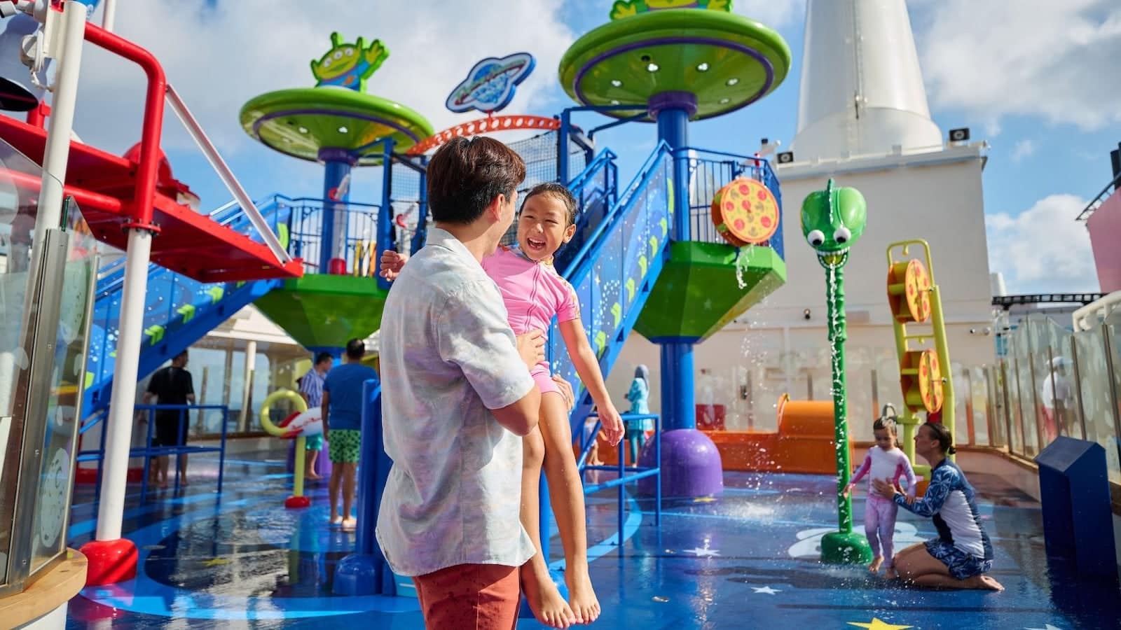 Families enjoying the Toy Story Place splash zone and family pool on the Disney Adventure cruise ship