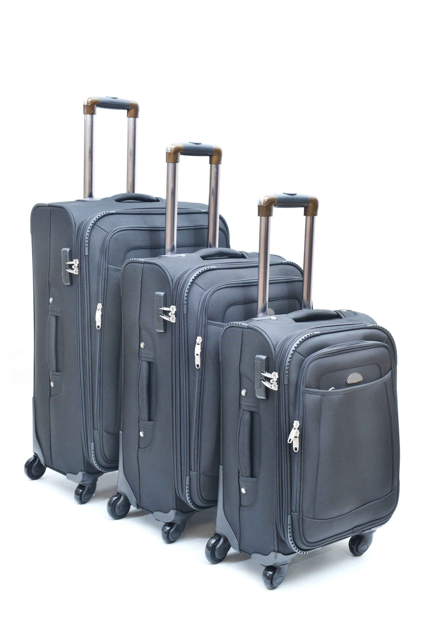 A set of gray suitcases in several sizes for comparing carry-on and checked baggage