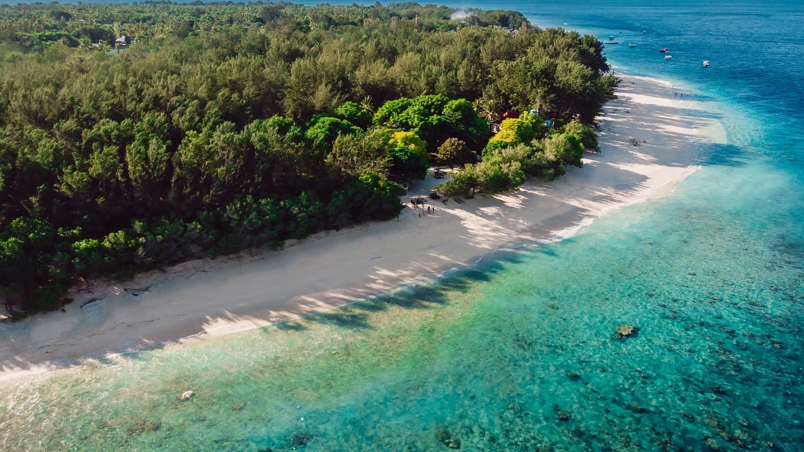 Aerial view of a secluded tropical island with a white sand beach and turquoise water, evoking RelaxAway, Half Moon Cay