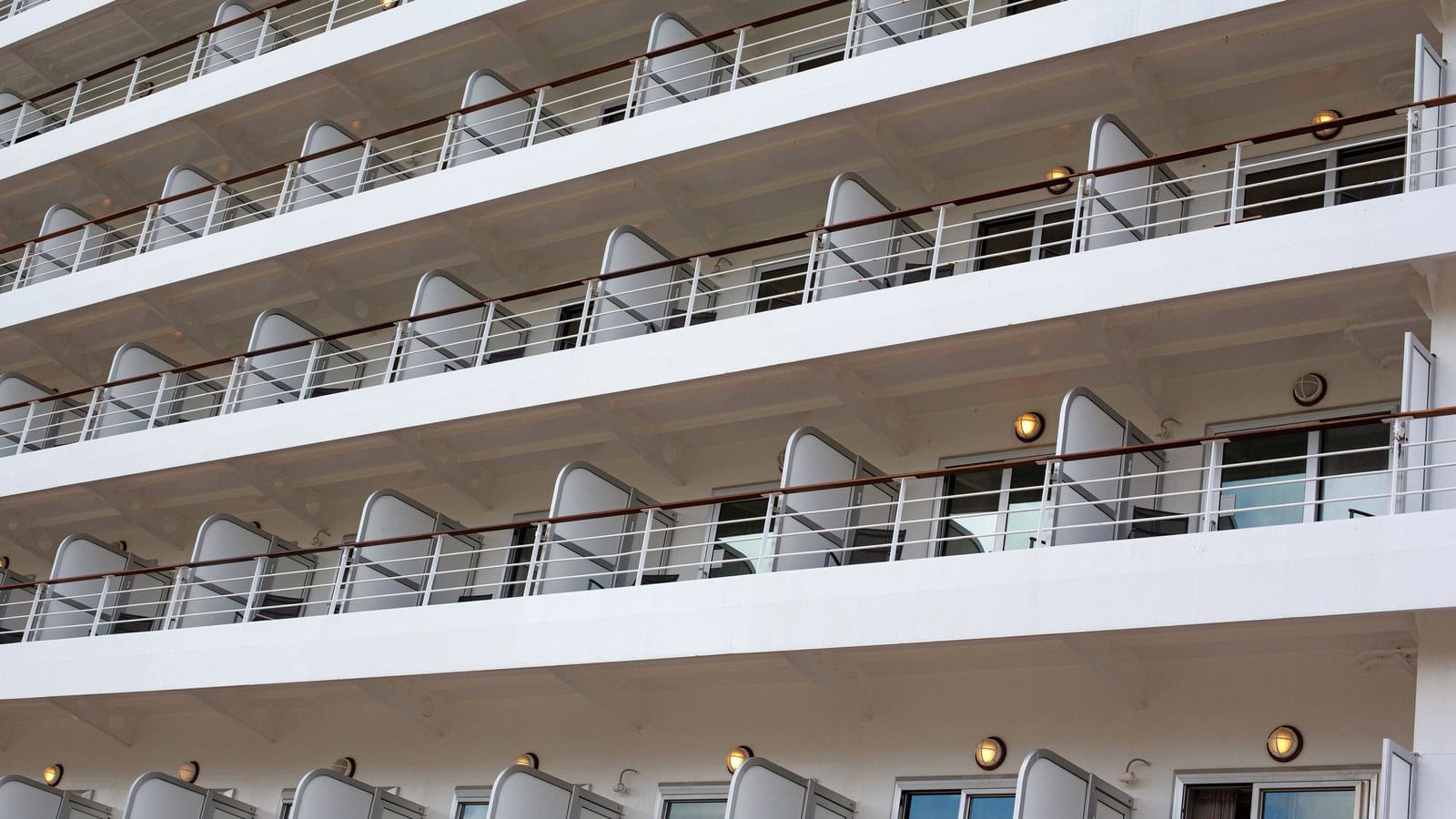 Rows of balcony cabins on the side of a cruise ship