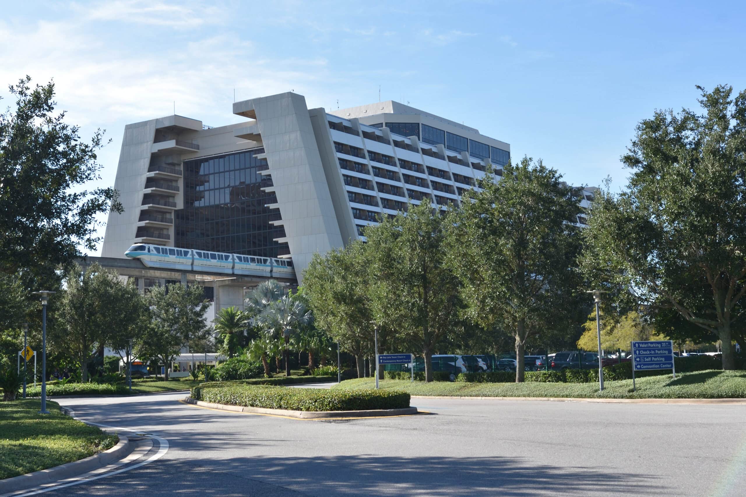 Disney's Contemporary Resort in Florida, showing a teal Monorail arriving at the iconic A frame building.