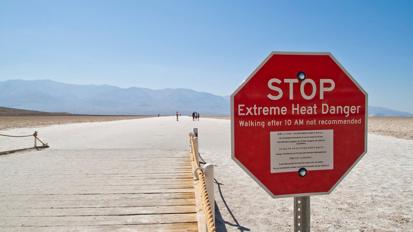 Extreme heat danger warning sign at Badwater Basin in Death Valley National Park, advising against walking after 10 a.m.