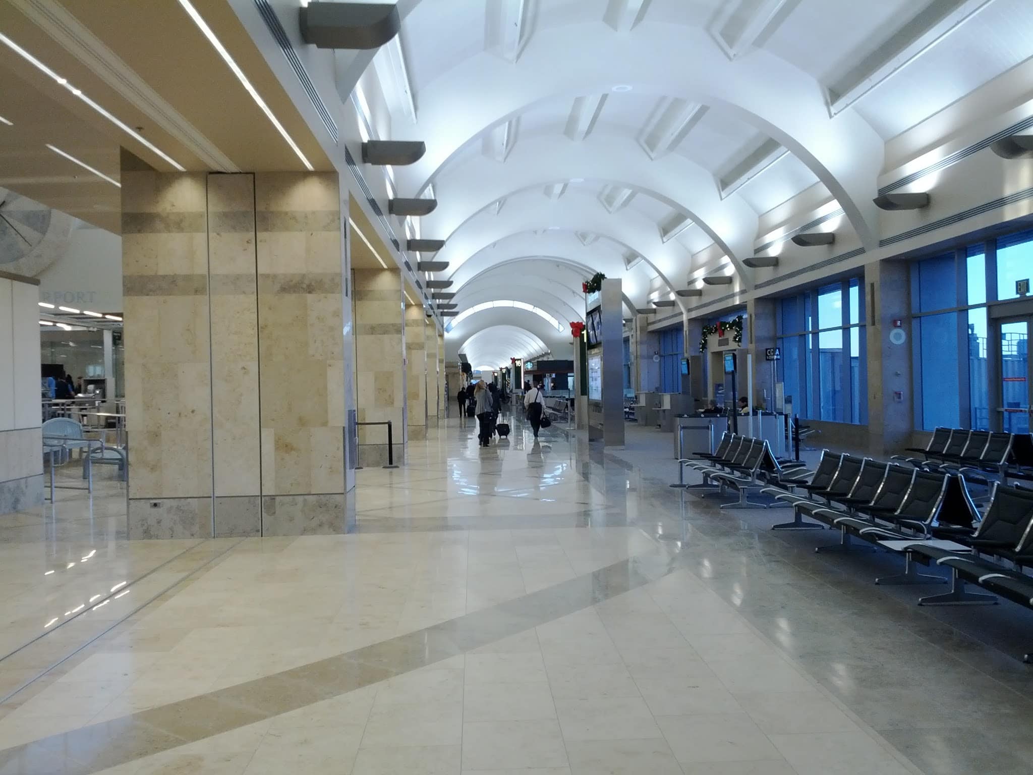The bright modern passenger gate and seating areas inside Terminal C of John Wayne Airport in Orange County California