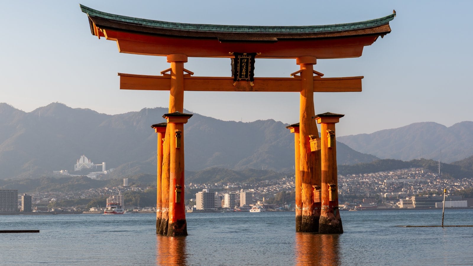 The vermilion floating torii gate of Itsukushima Shrine standing in the sea at Miyajima, Japan