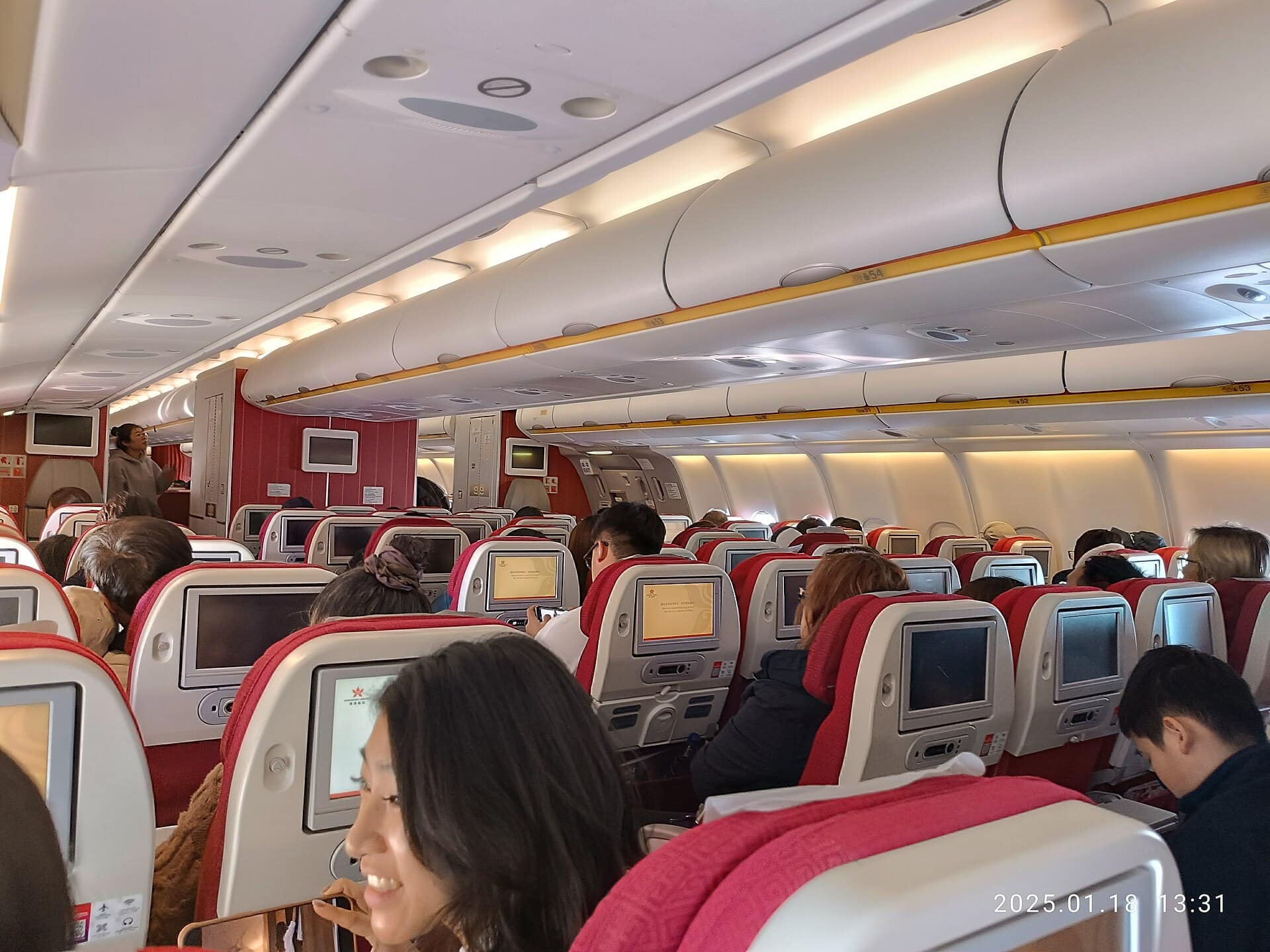 Airplane economy seats showing the space where a personal item fits under the seat