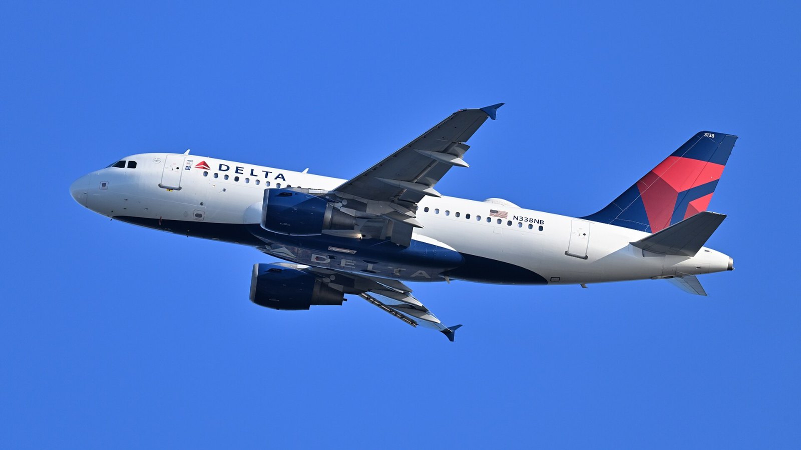 A Delta Air Lines Airbus A319 jet climbing after departing Boston.