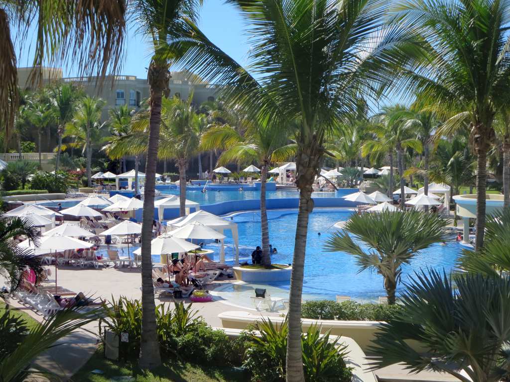 The spectacular three level swimming pool complex overlooking the gardens and ocean at a luxury resort in Mexico