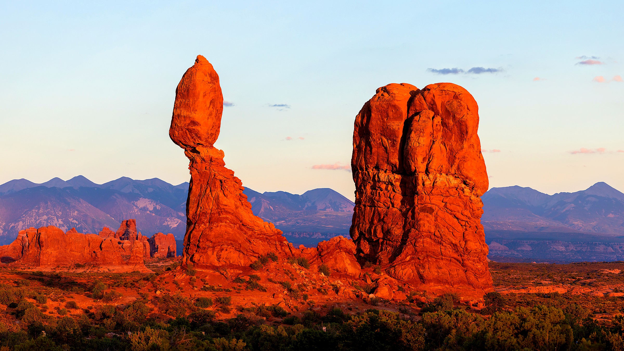 Natural sandstone arches above desert fins at Arches National Park