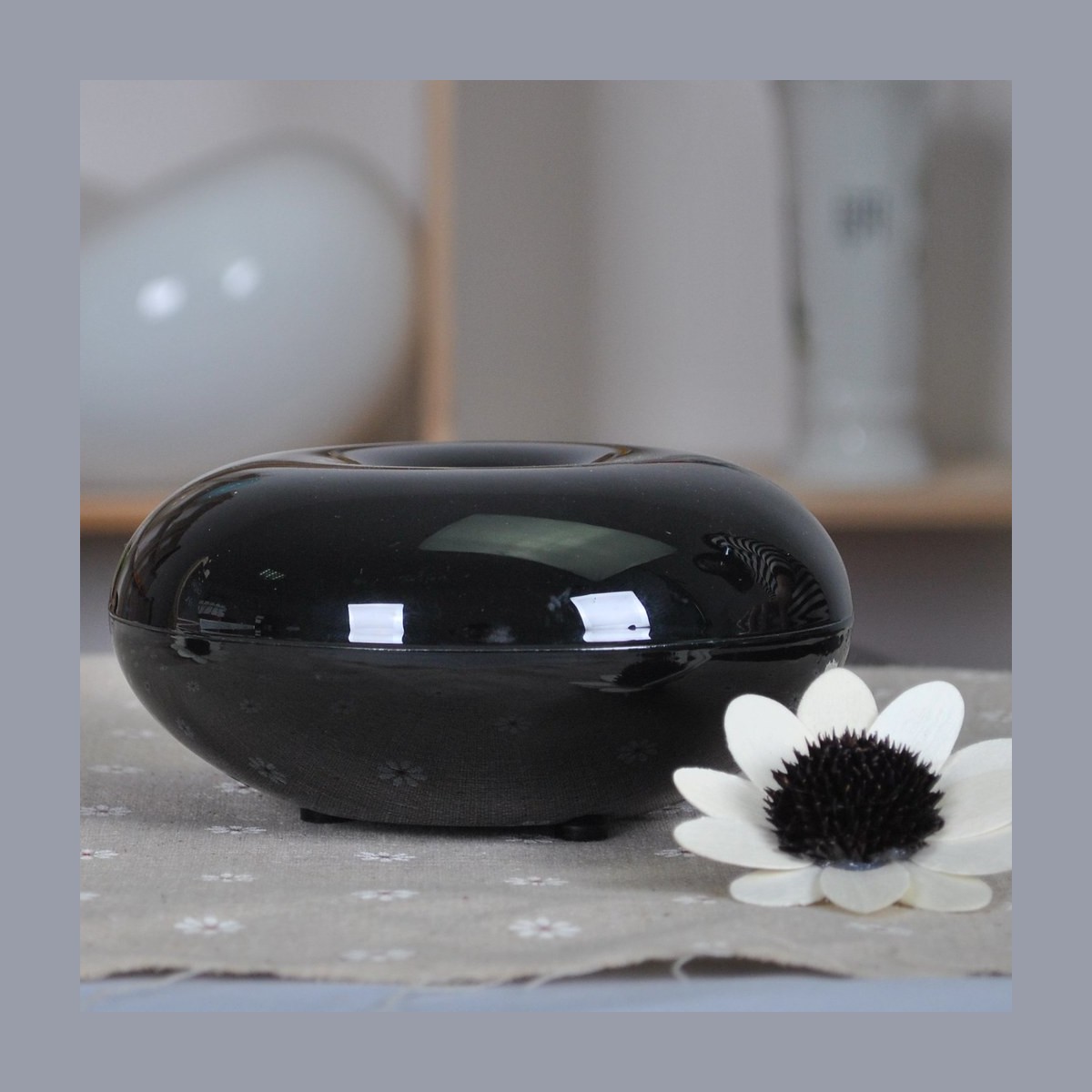 Essential oil diffuser and bottles on white
