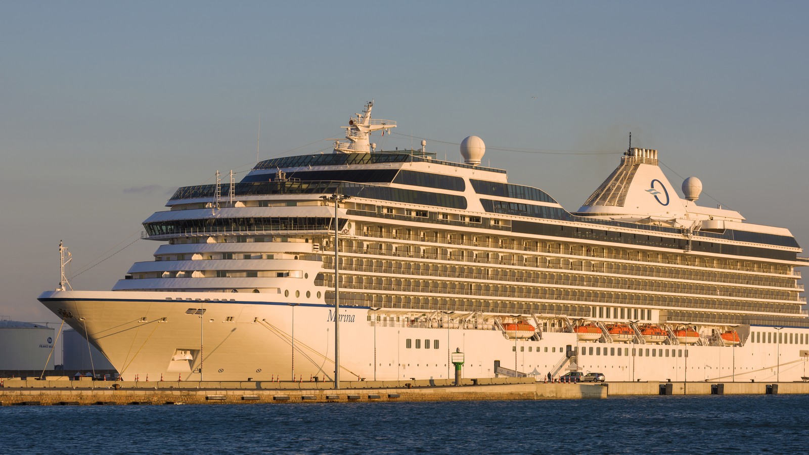 Oceania Marina cruise ship docked at Sete showing bow name and full starboard profile