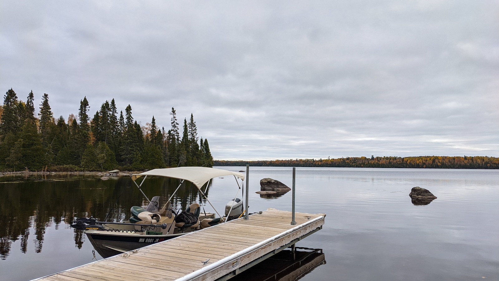 Bright autumn shoreline and dock on Windy Lake in Superior National Forest Minnesota