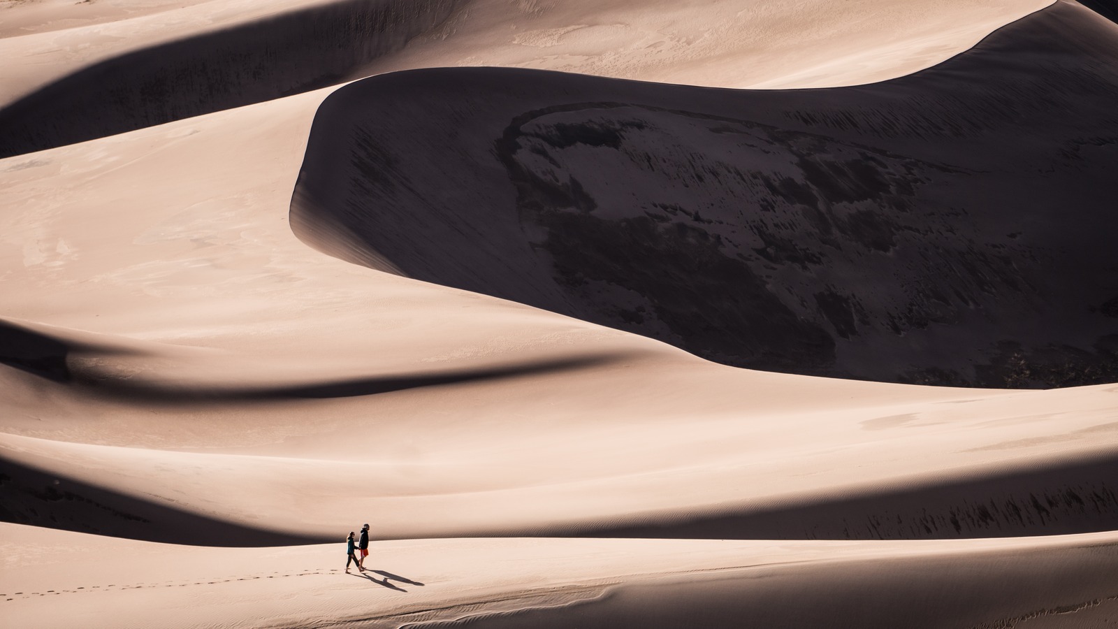 Bright sand dunes and distant mountains at Great Sand Dunes National Park and Preserve in Colorado