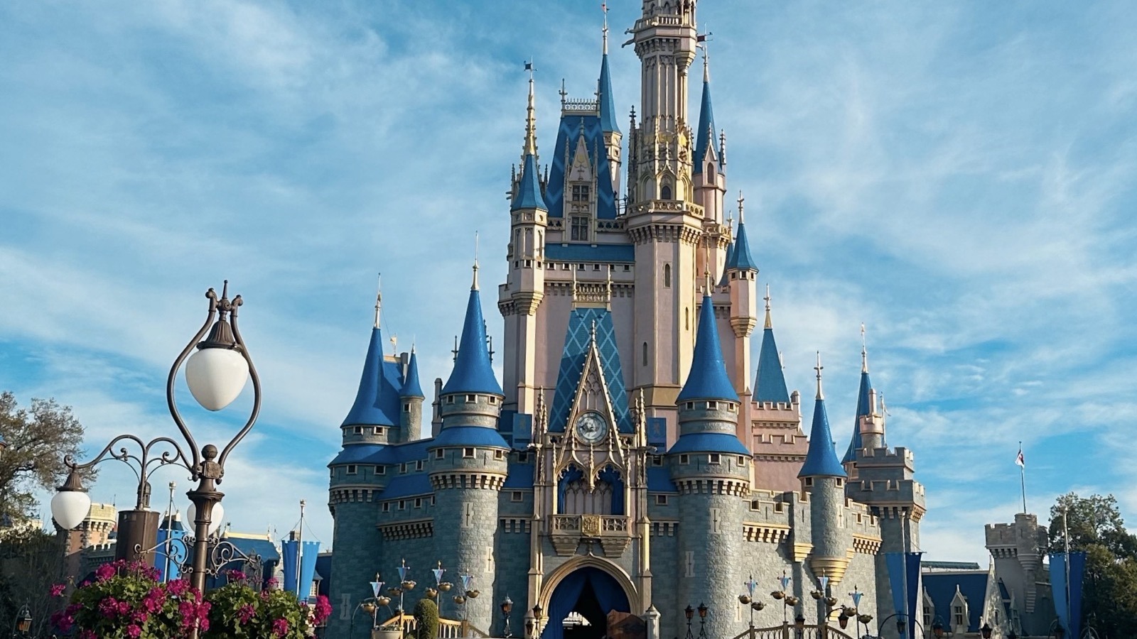 Cinderella Castle at Magic Kingdom under a bright blue sky