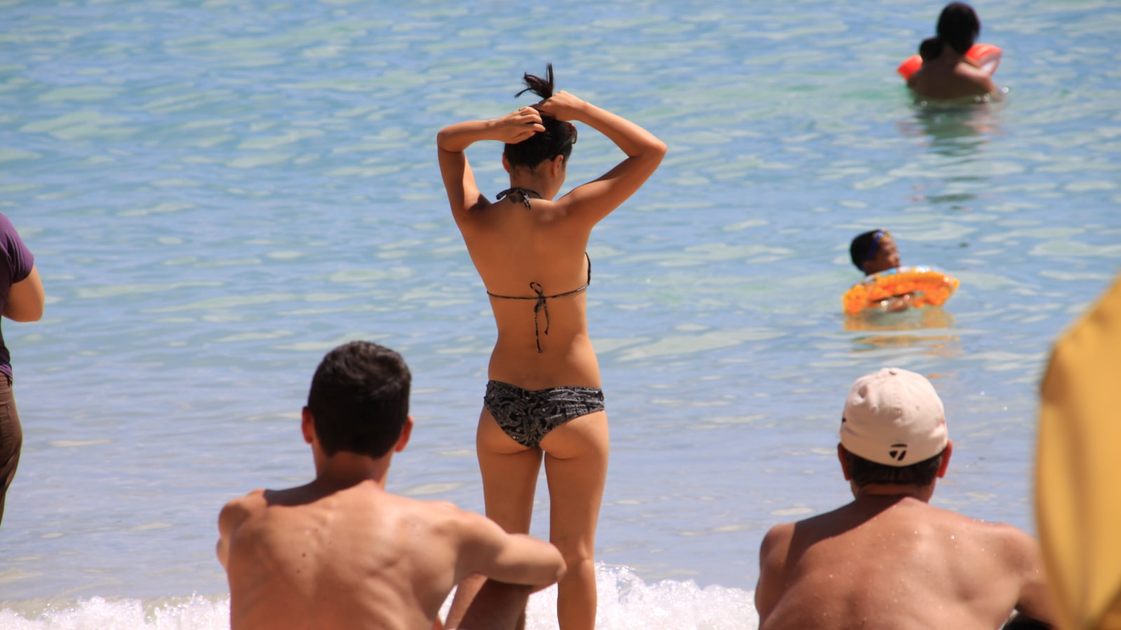 People on Waikiki Beach in Honolulu with ocean and sky