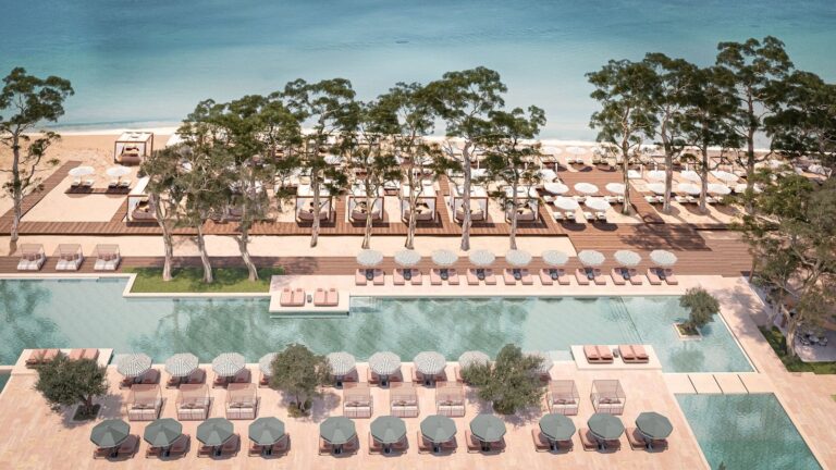 Outdoor swimming pool and lounge area at Conrad Corfu beachfront resort