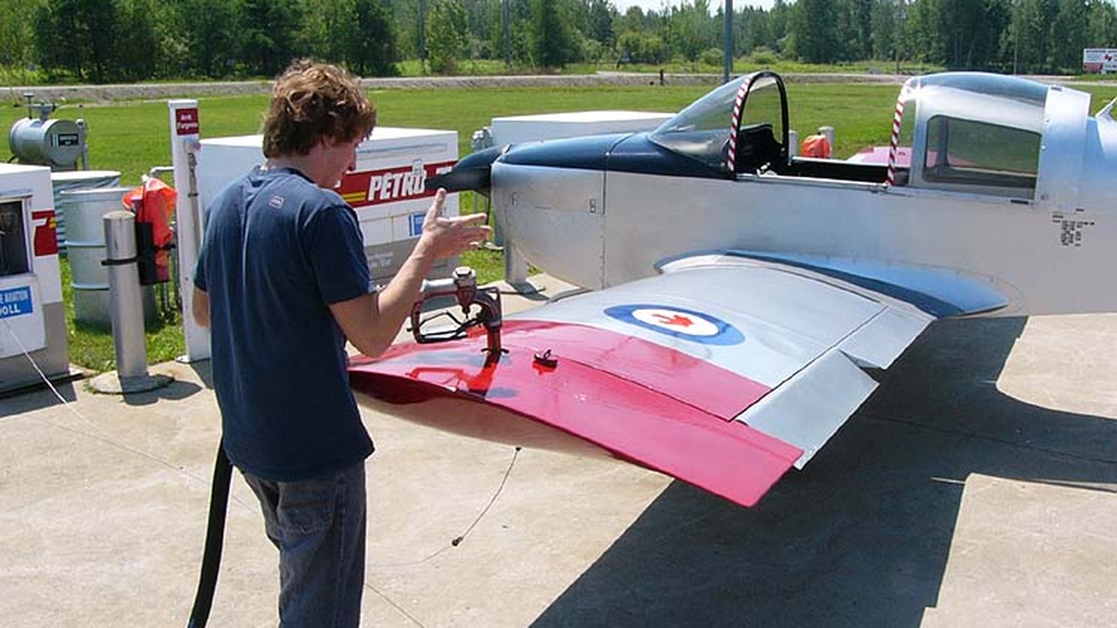 General aviation piston aircraft refueling at a self-serve airport fuel pump