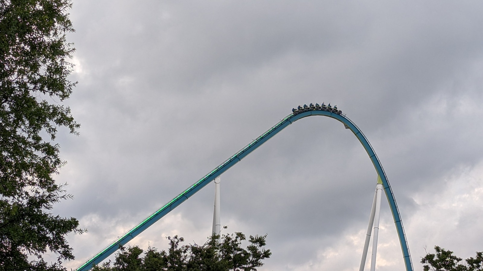 Fury 325 train crests a high hill at Carowinds under a cloudy sky