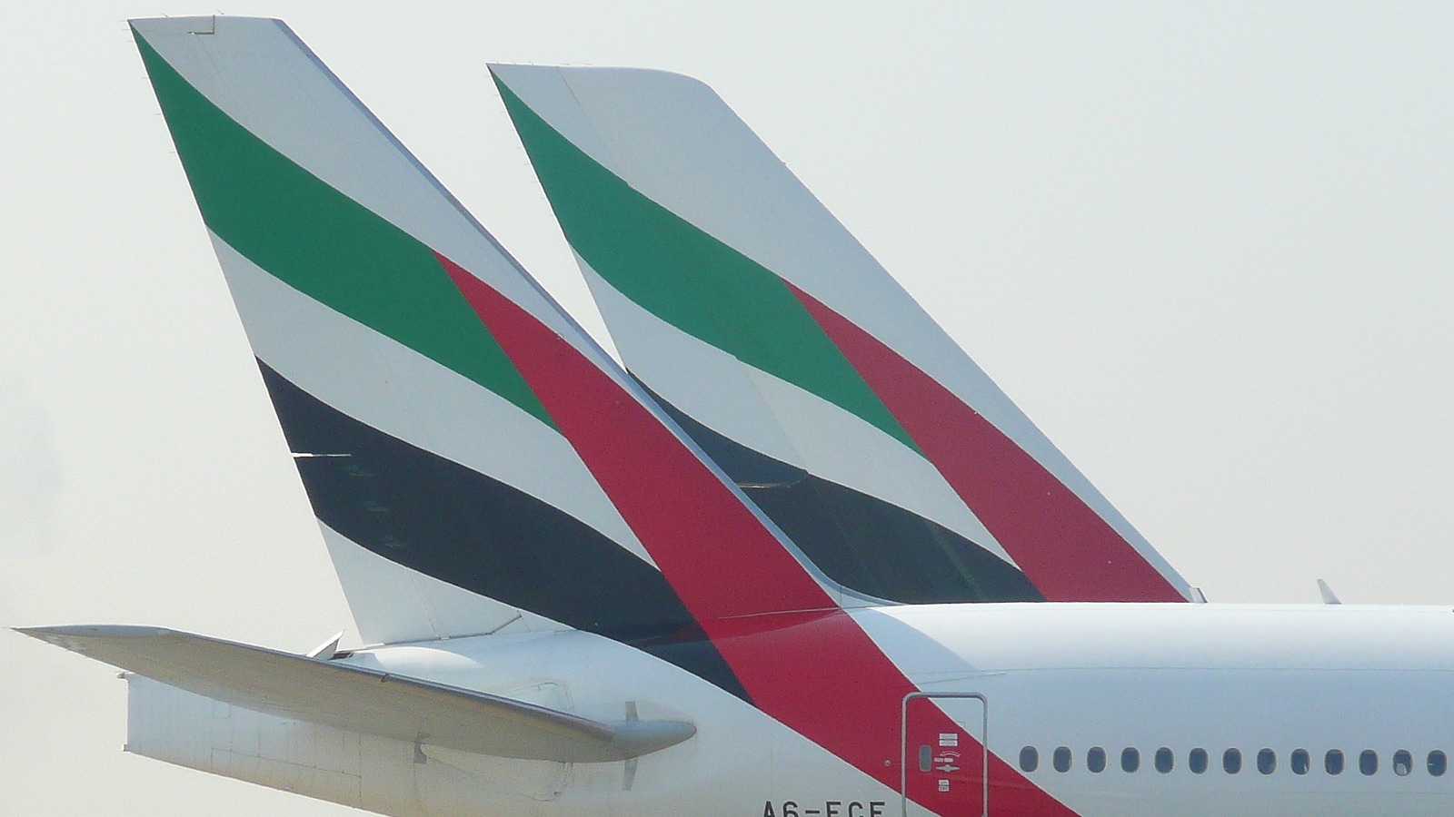 Emirates Boeing 777 twin-engine jet climbing after takeoff with Emirates titles visible