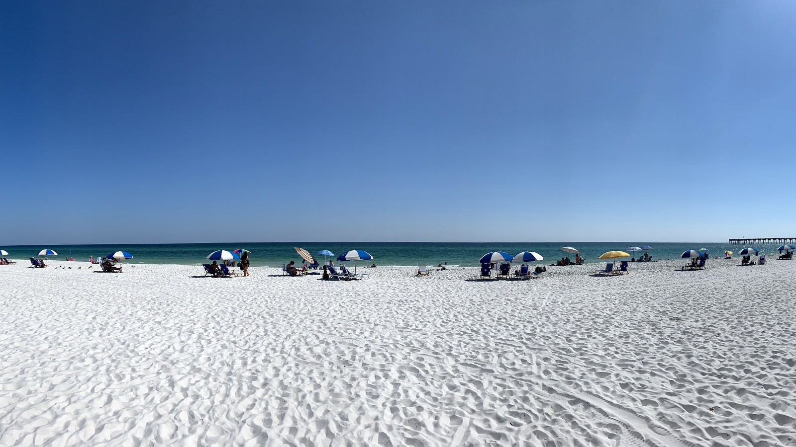 Wide view of Pensacola Beach shoreline and turquoise water in Florida