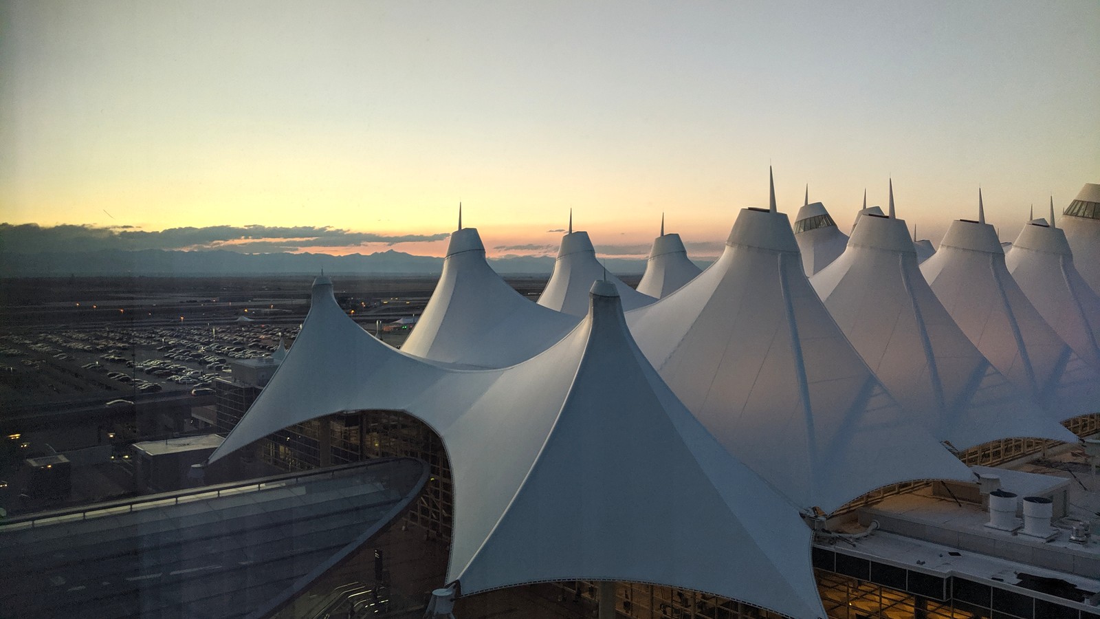 Denver International Airport main terminal exterior at dusk