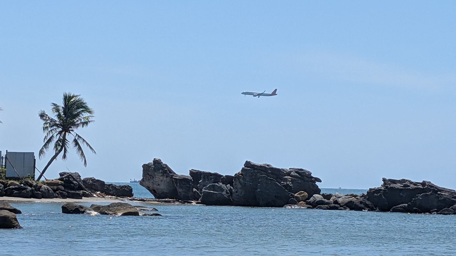 Phu Quoc beach shoreline with an airplane overhead