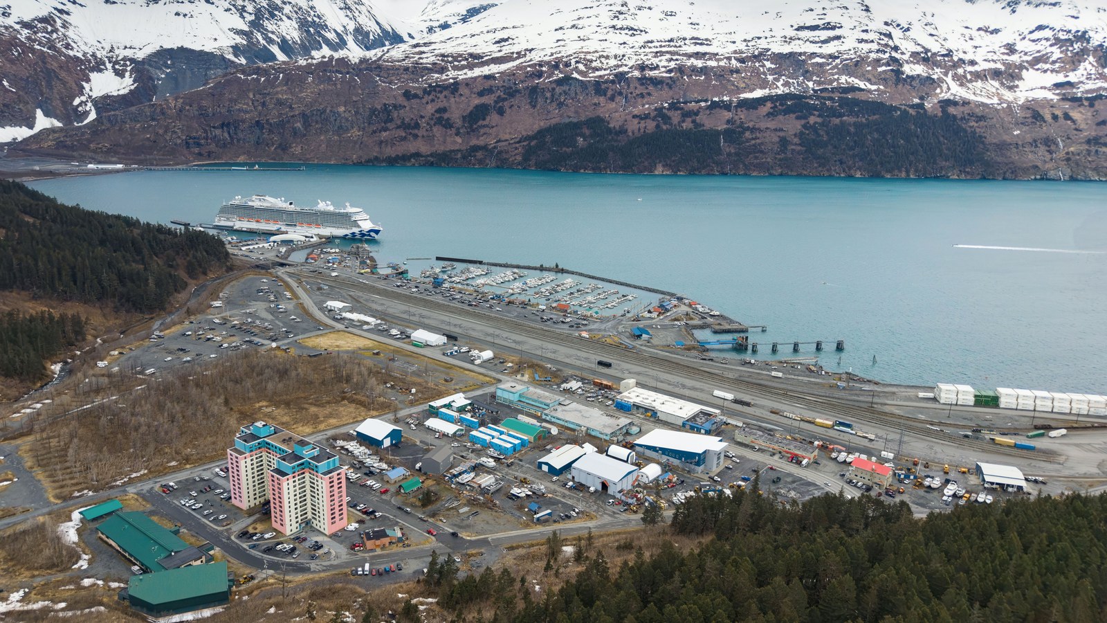 Aerial view of Whittier, Alaska showing the cruise terminal, harbor, rail lines and road network in May 2026
