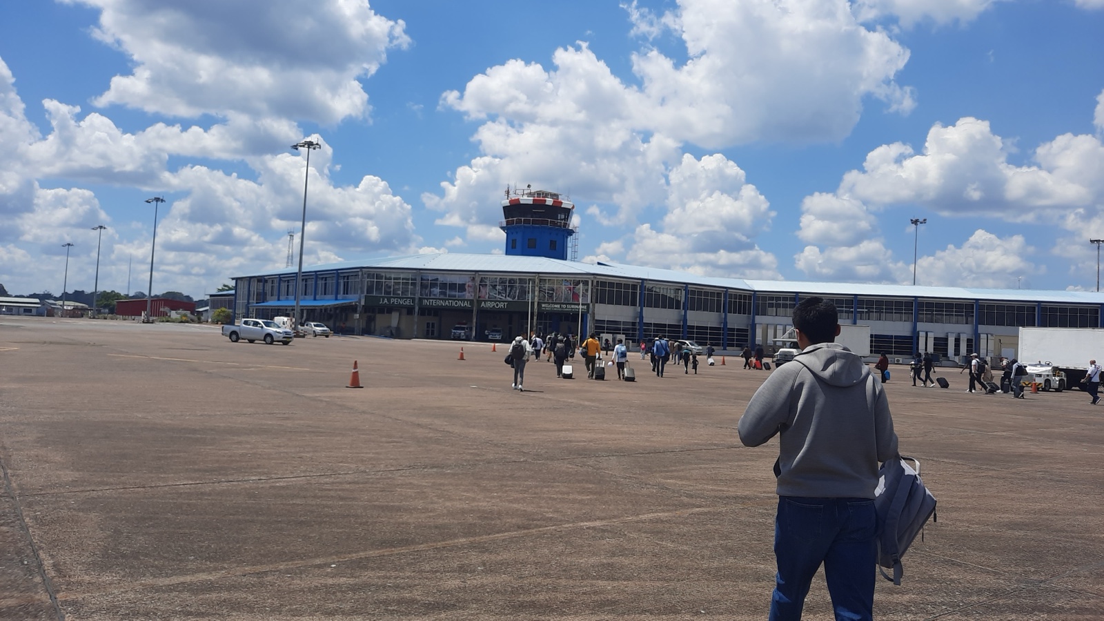 Travelers walking toward the terminal at Johan Adolf Pengel International Airport in Suriname