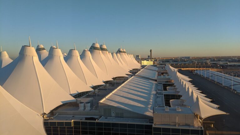 Denver International Airport Jeppesen Main Terminal exterior with peaked roof at early morning light