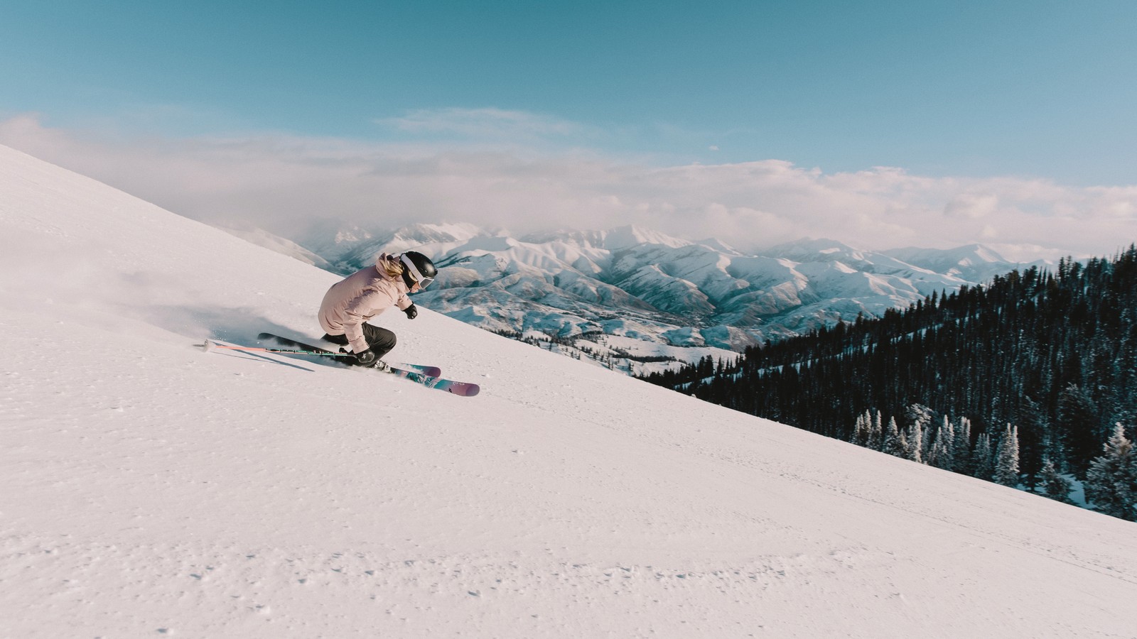 Skiers on Bald Mountain at Sun Valley Resort under blue sky