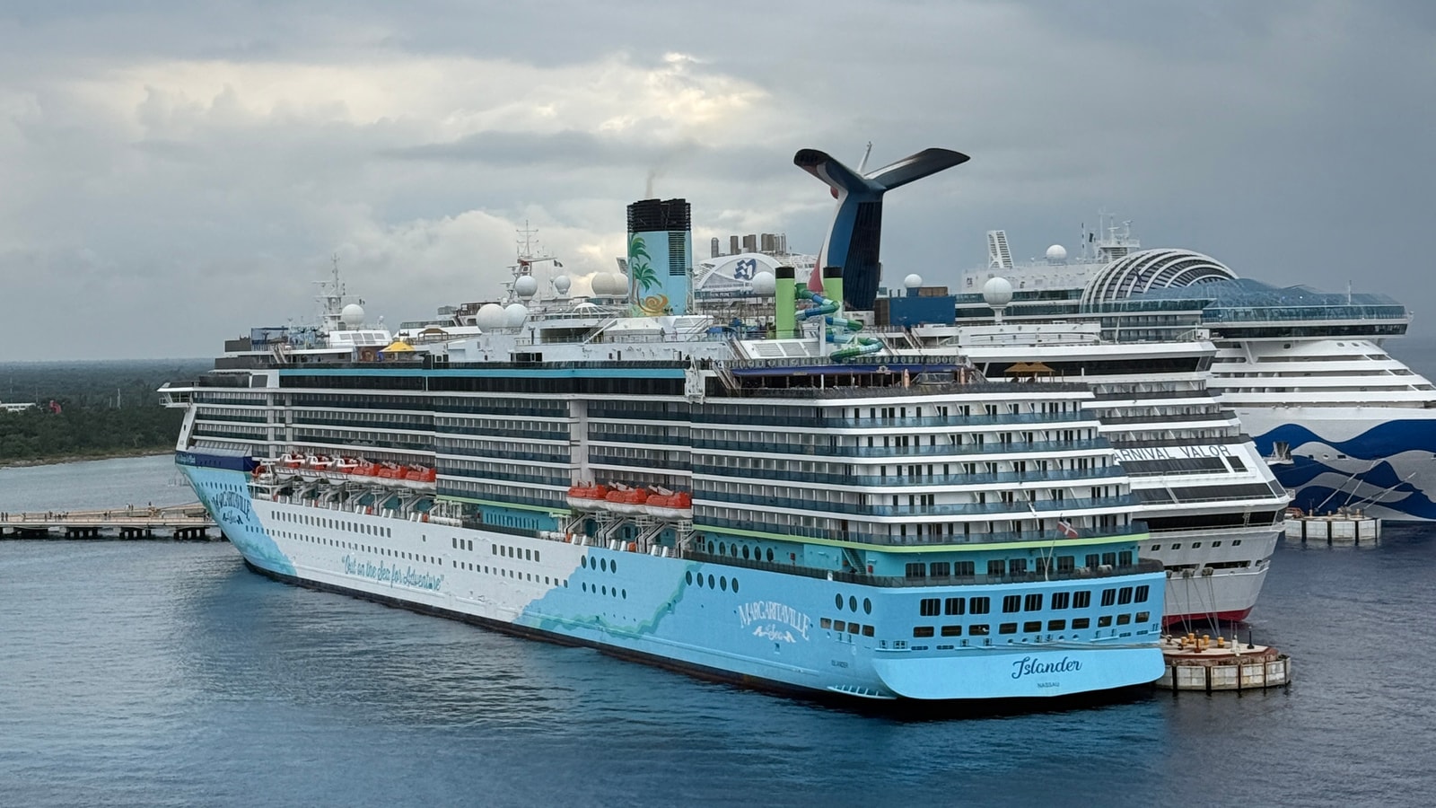 Margaritaville at Sea Islander docked beside another cruise ship in November 2024