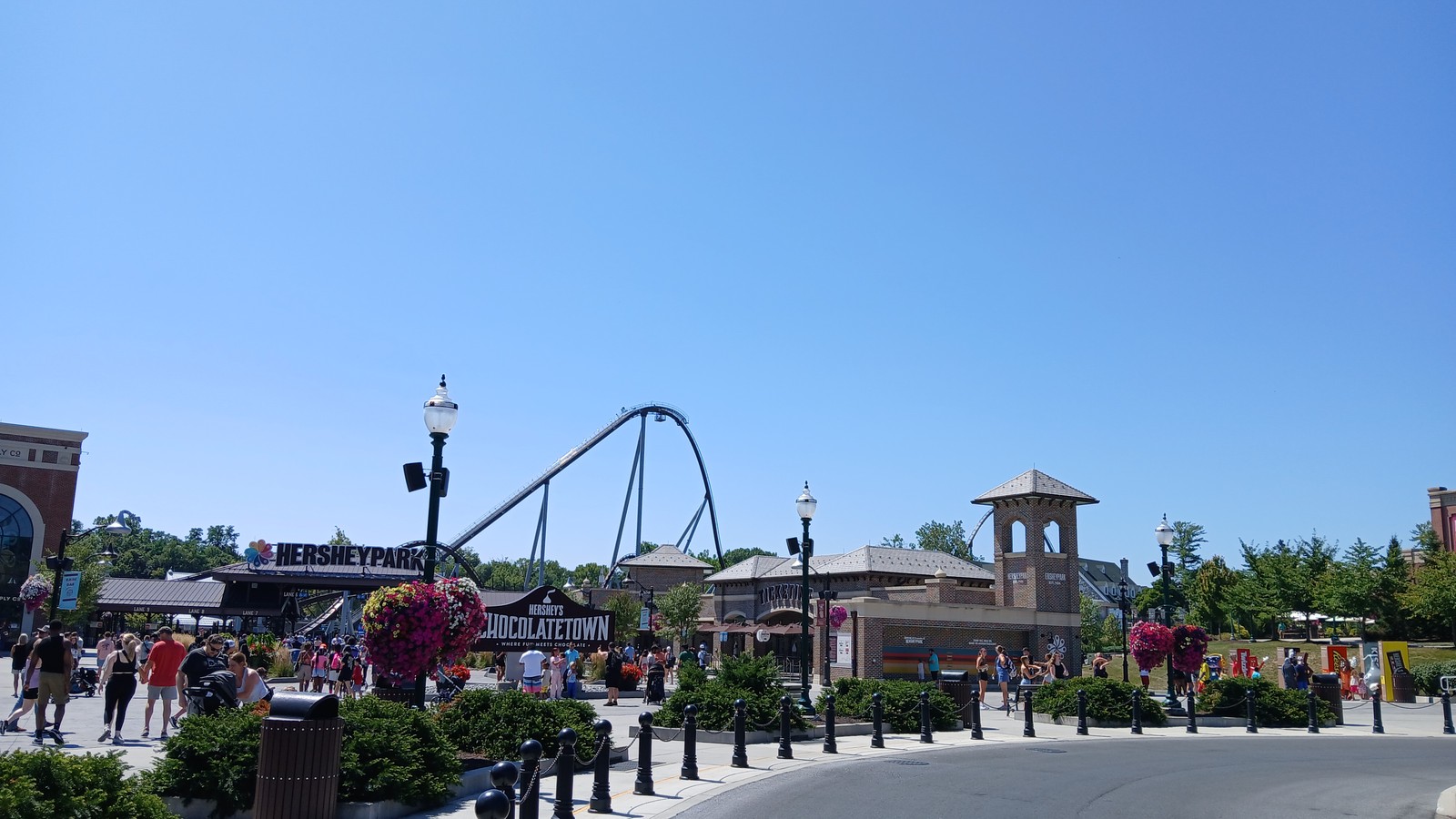 Candymonium coaster and Hersheypark entrance plaza under a bright sky in Hershey Pennsylvania