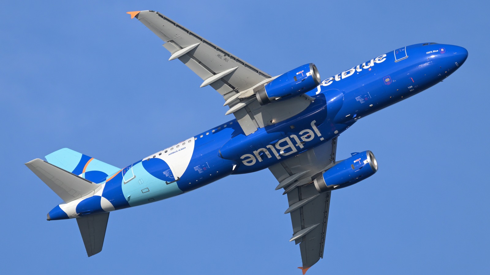 JetBlue Airbus A320 N796JB climbing against clear blue sky with JetBlue titles readable on the fuselage