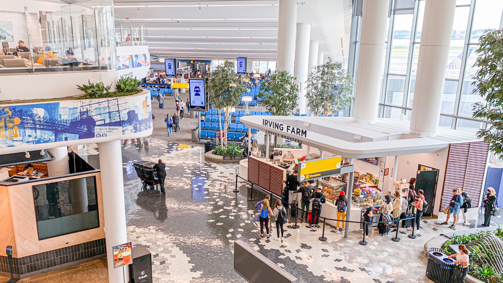 Interior of LaGuardia Airport Terminal B with travelers in a bright modern hall