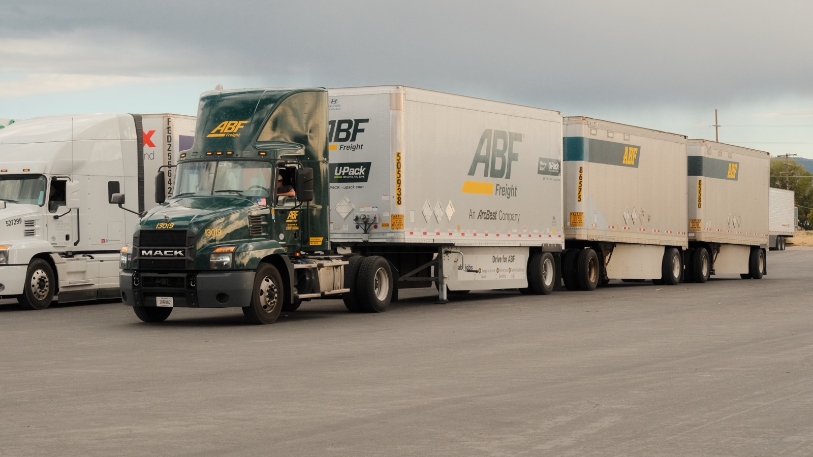 Freight trucks parked in Beaver, Utah, under cloudy skies