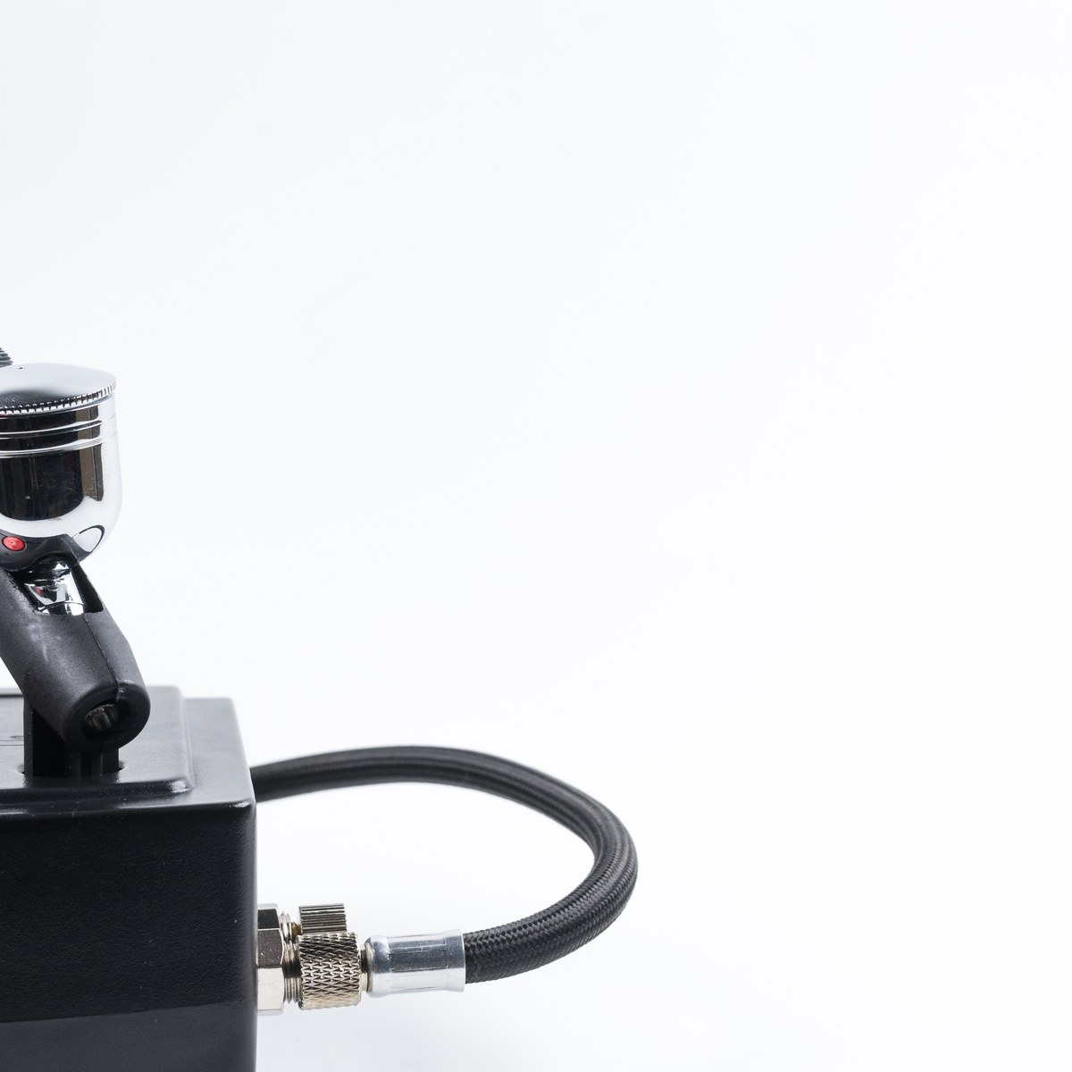 Airbrush makeup gun and compressor on a white background