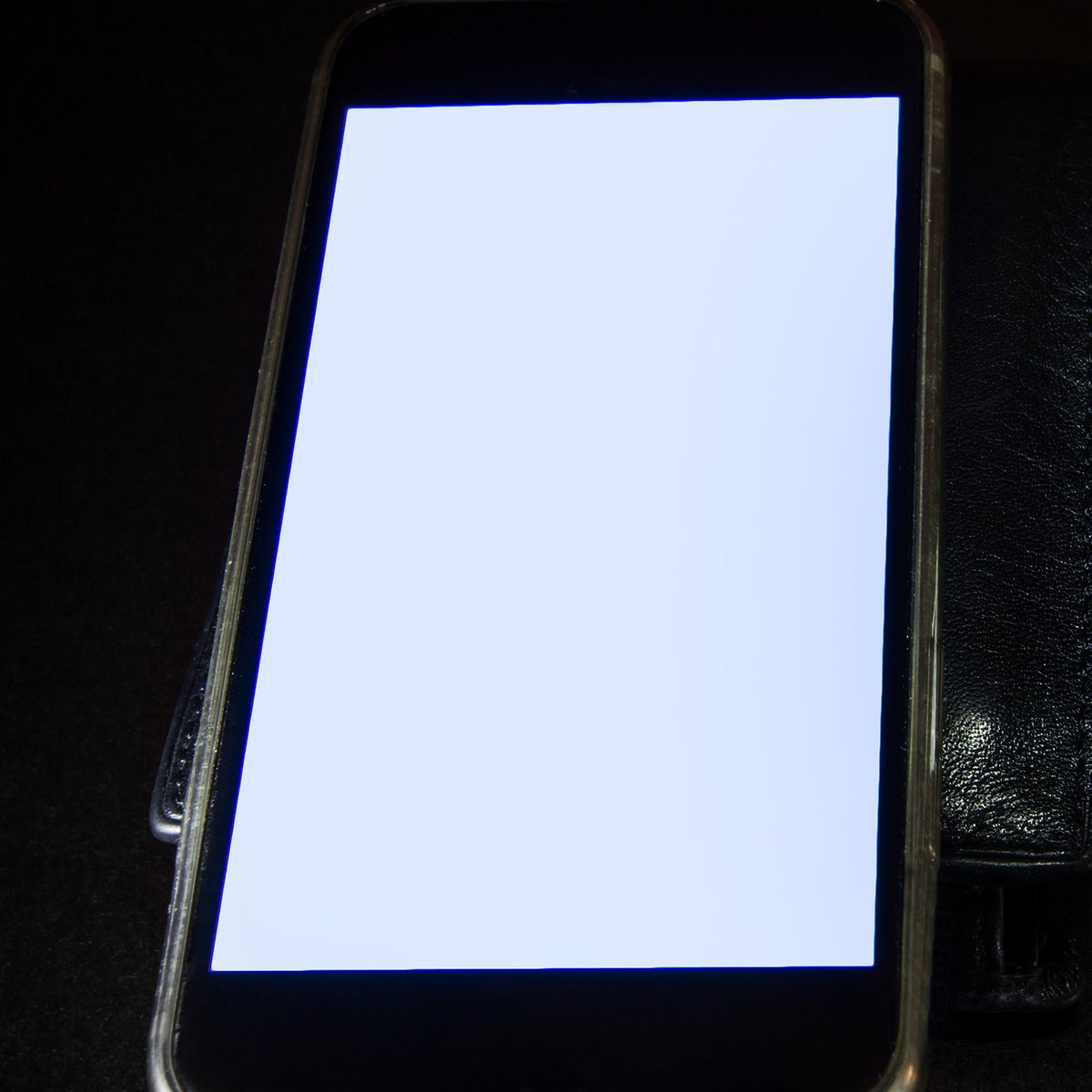 Smartphone with a blank screen on a dark background