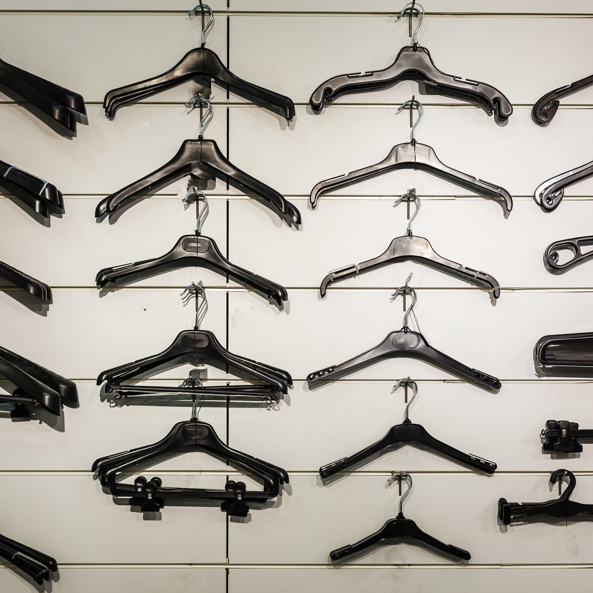 Row of black coat hangers on a rack