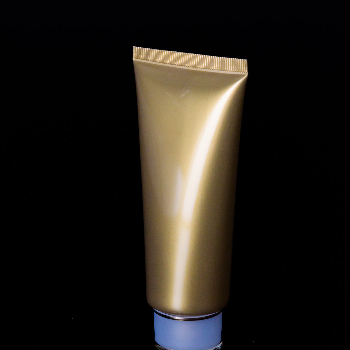 Cosmetic conditioner tube on a black background