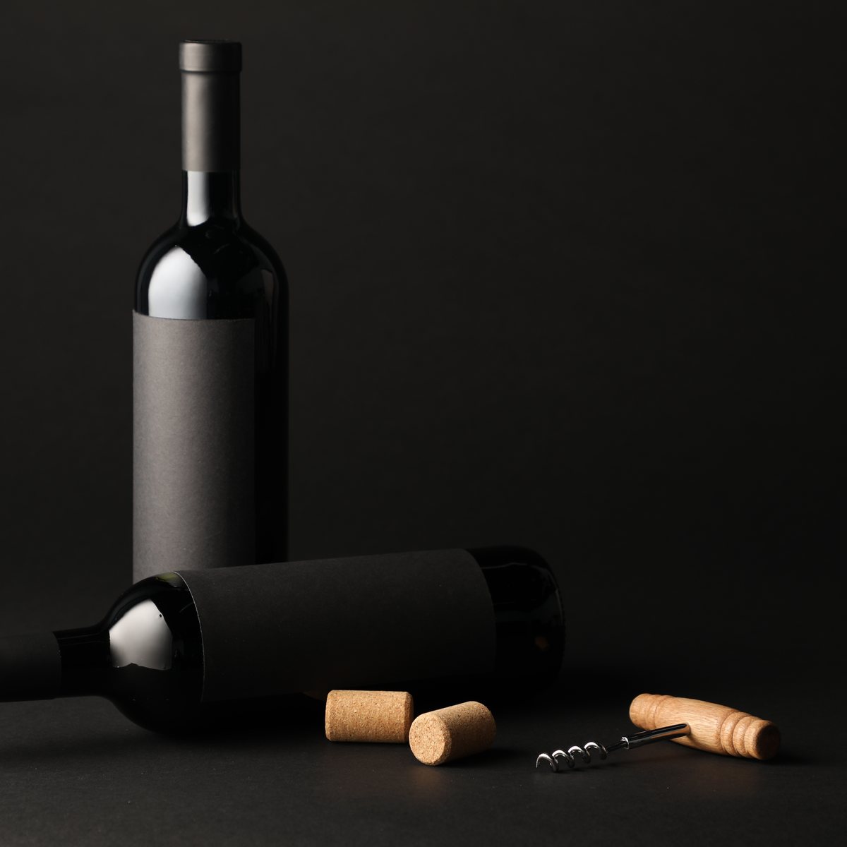 Waiter style corkscrew with wine corks on a dark background