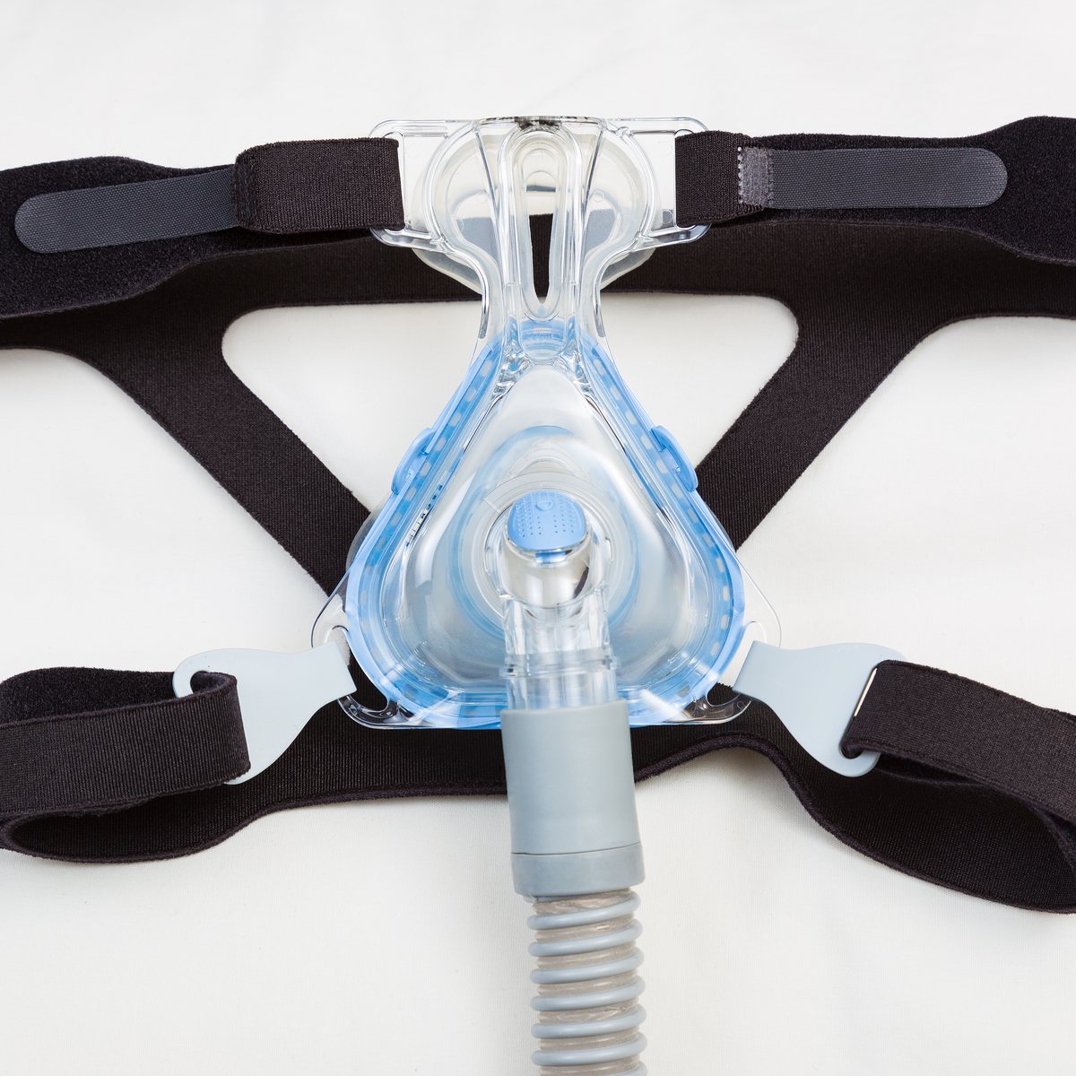 CPAP mask and hose on a dark background