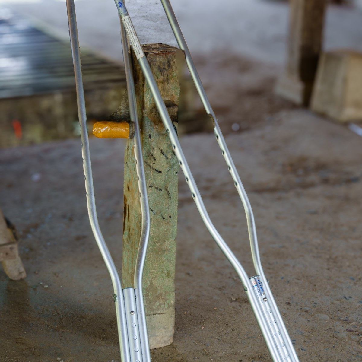 Pair of crutches leaning against a wall