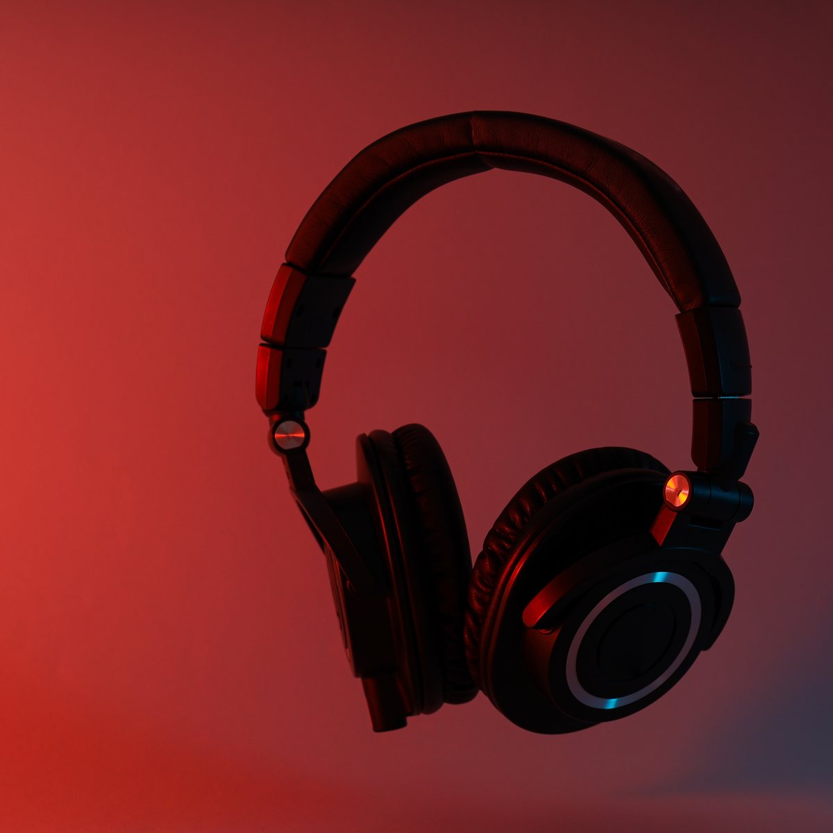 Over-ear headphones on a red background