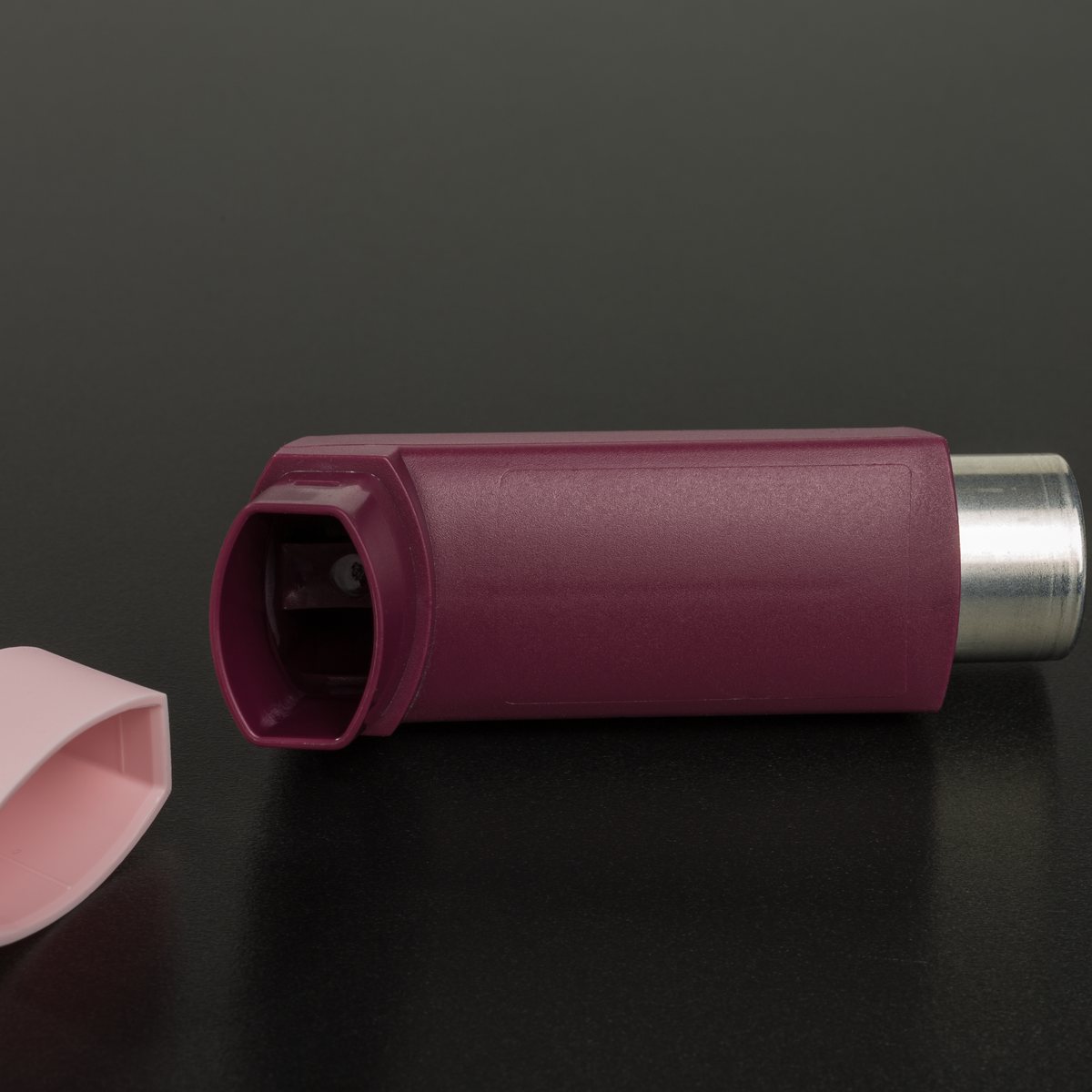 Asthma inhaler on a dark background