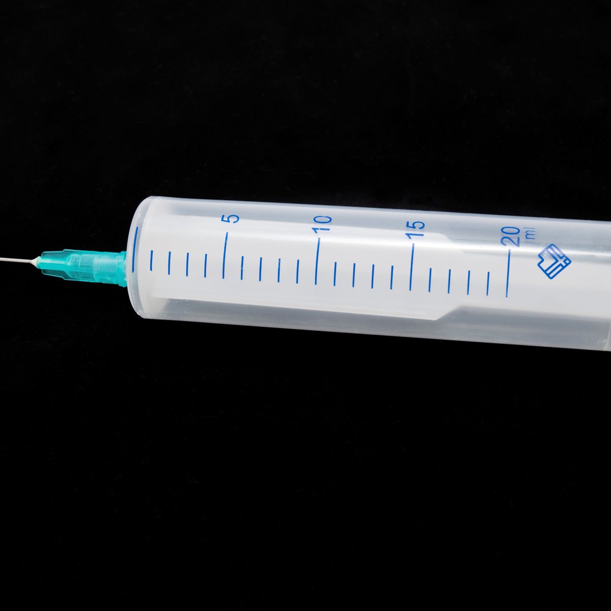 Medical syringe on a black background