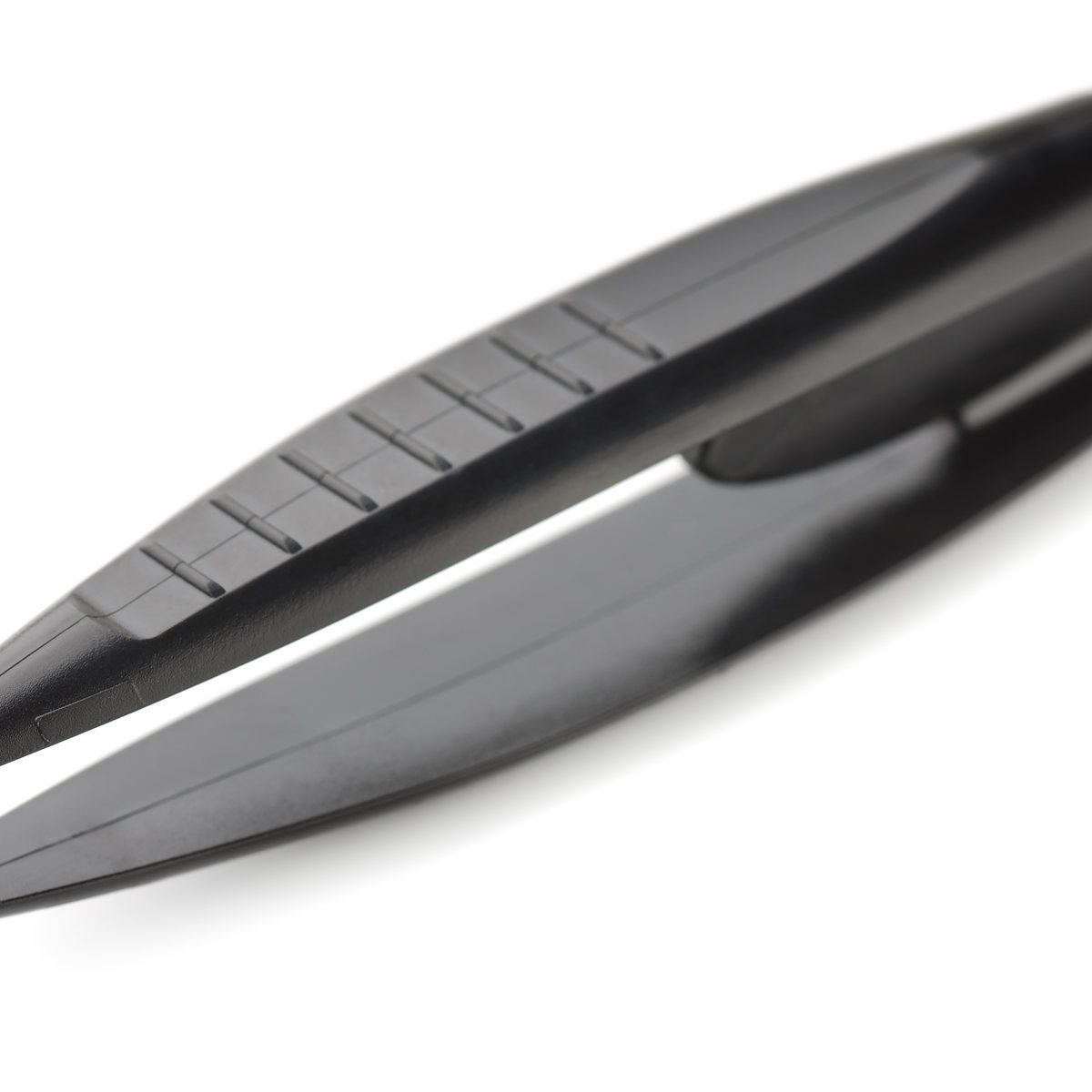 Close-up of slanted metal tweezers on a light background