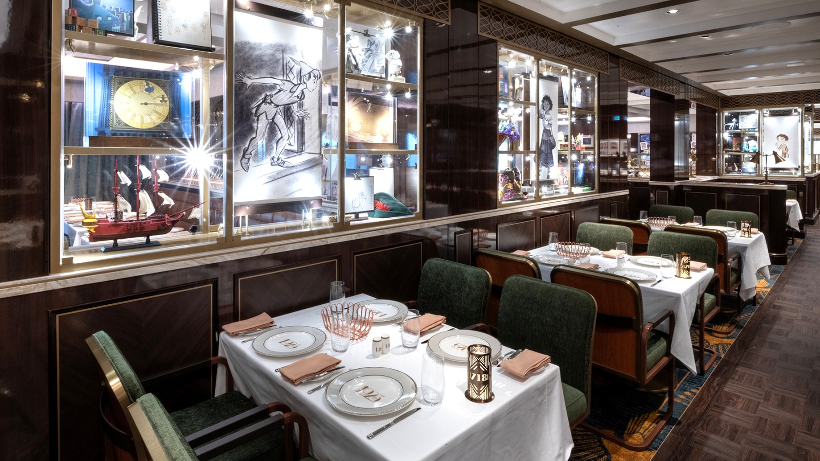 1923 restaurant dining room on the Disney Treasure with green leather seating and Disney animation artwork